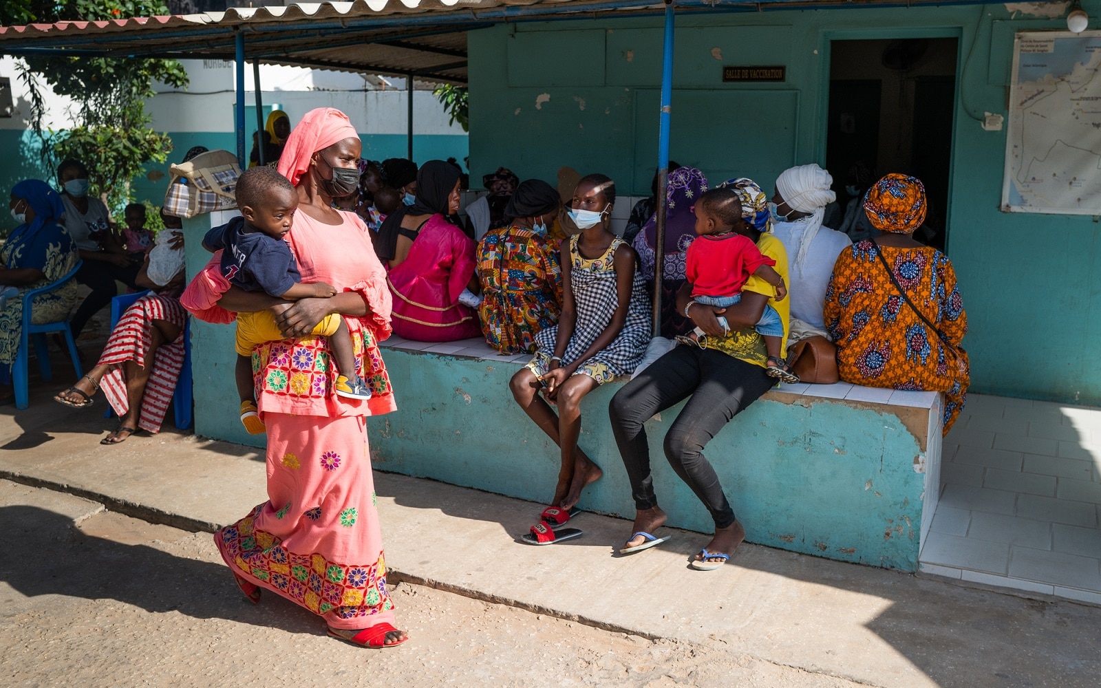 A mother waits for her 1-year-old son to receive a second dose of the measles vaccine in Dakar, Senegal.