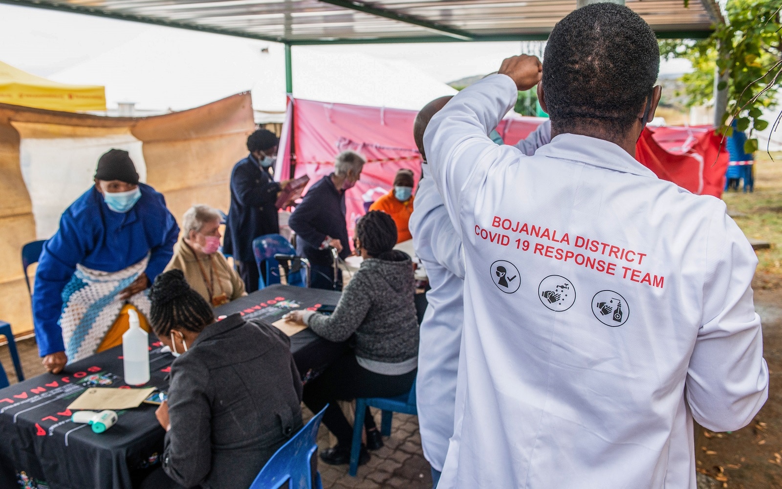 A health worker directs elderly residents to register for a COVID-19 vaccination program in Brits, South Africa.