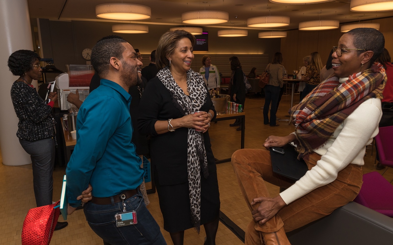 The foundation’s Chief Diversity, Equity, and Inclusion Officer, Leslie Mays, speaks with colleagues Nate Simpson and Robin Martin at an employee event in Seattle, Washington. 