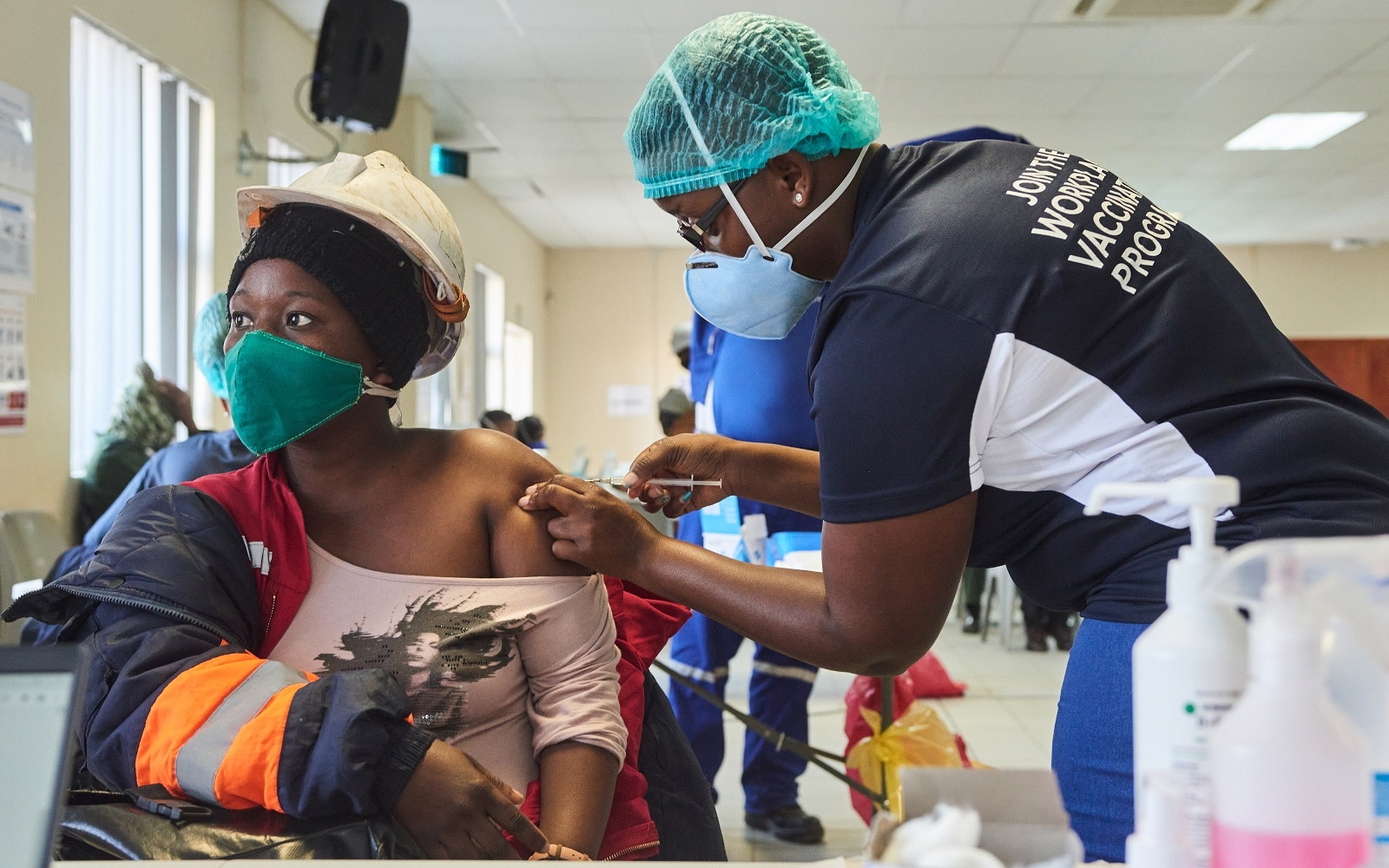 A miner receives a dose of the COVID-19 vaccine at Anglo American Platinum Ltd.'s Tumela mine in Amandelbult, South Africa. South African companies are playing a crucial role in helping the government counter the ravages of the pandemic among remote communities.